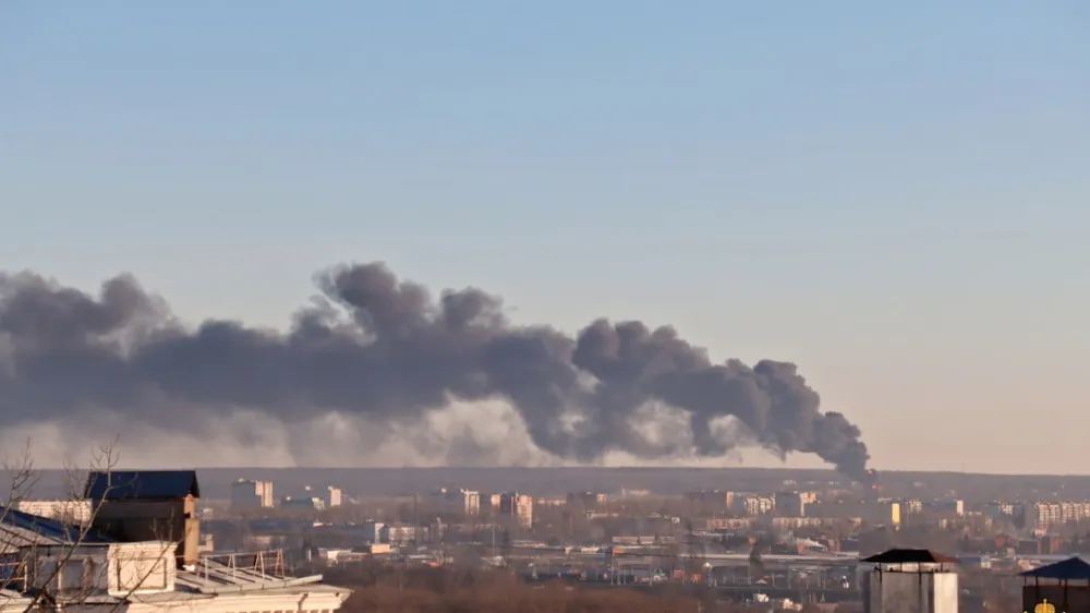 In this handout photo released by the administration of the Kursk region of Russia on Tuesday, Dec. 6, 2022, smoke rises from the area of Kursk airport outside Kursk, Russia. A fire that broke out at an airport in Russia's southern Kursk region that borders Ukraine was the result of a drone attack, the Kursk regional governor said Tuesday, a day after Moscow blamed Kyiv for drone strikes on two air bases deep inside Russia and launched a new wave of missile strikes on Ukrainian territory. (Administration of the Kursk region of Russia via AP)