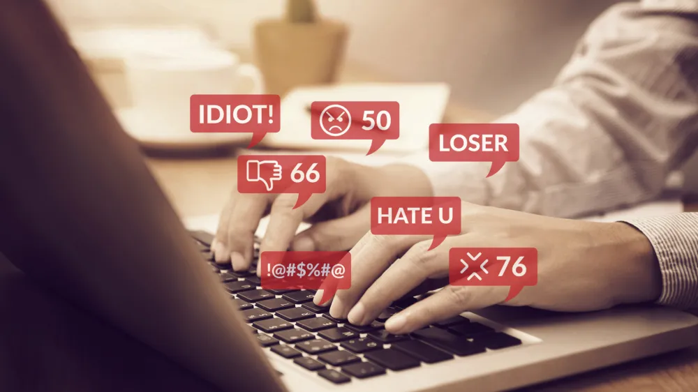 cyber bullying concept. people using notebook computer laptop for social media interactions with notification icons of hate speech and mean comment in social network