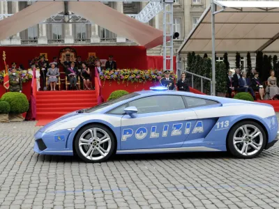 A Lamborghini car of the Italian Police passes in front of the Royal tribune during a military parade in front of the Royal Palace in Brussels, Wednesday July 21, 2010, for Belgium's National Day. (AP Photo/Thierry Charlier)