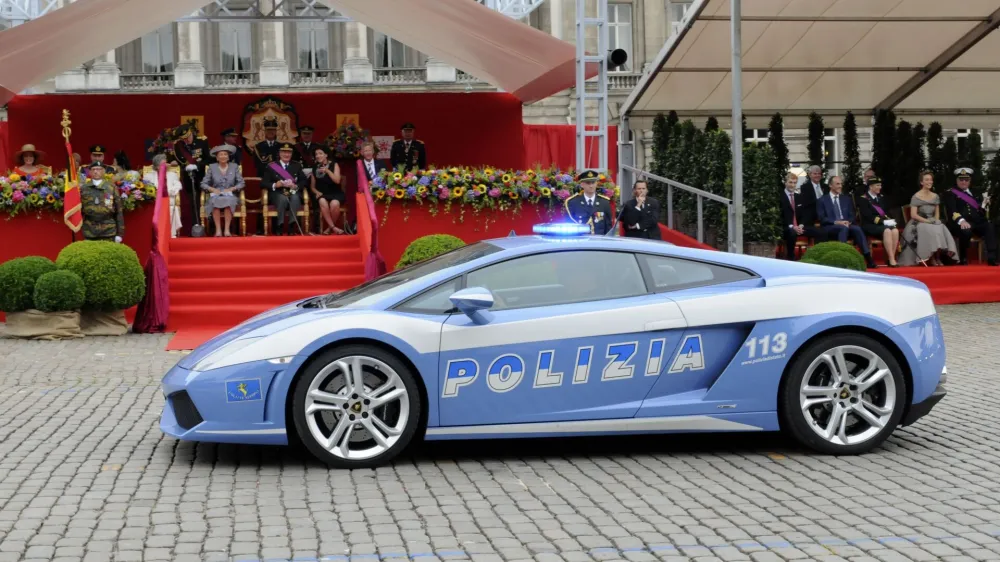 A Lamborghini car of the Italian Police passes in front of the Royal tribune during a military parade in front of the Royal Palace in Brussels, Wednesday July 21, 2010, for Belgium's National Day. (AP Photo/Thierry Charlier)