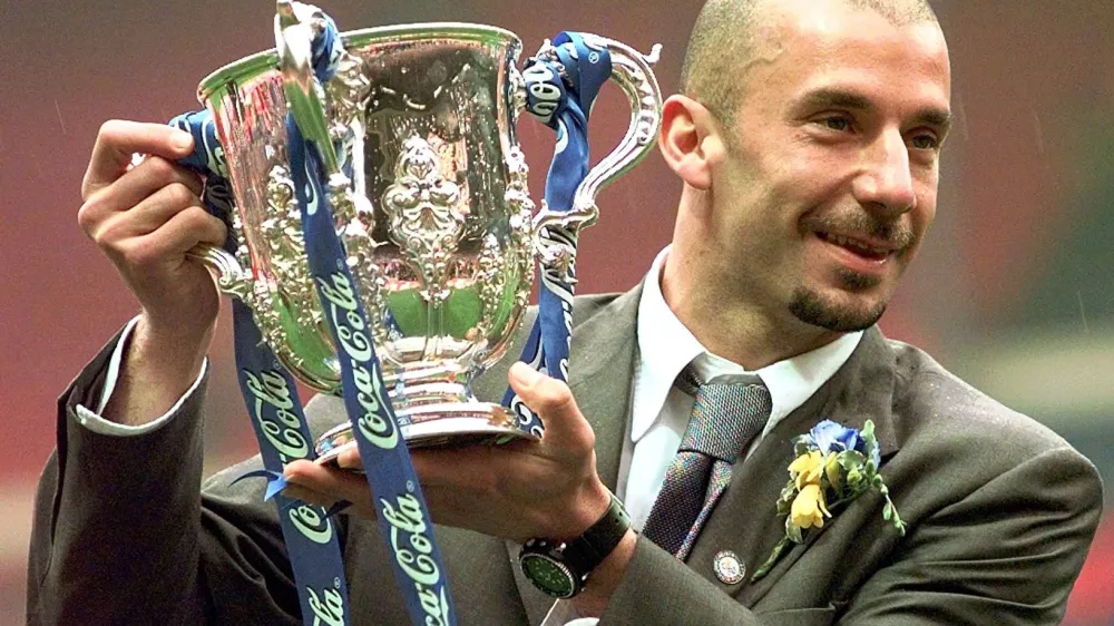 FILE - Chelsea's player and manager Gianluca Vialli celebrates with the Coca-Cola Cup trophy after his Chelsea team beat Middlesbrough 2-0 in the final at London's Wembley stadium, Sunday, March 29, 1998. Gianluca Vialli, the former Italy striker who helped both Sampdoria and Juventus win Serie A and European trophies before becoming a player-manager at Chelsea, has died on Friday, Jan. 6, 2023. He was 58. (AP Photo/Max Nash, File)