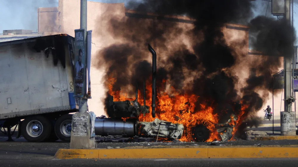 A truck burns on a street in Culiacan, Sinaloa state, Thursday Jan. 5, 2023. Mexican security forces captured Ovidio Guzm&aacute;n, an alleged drug trafficker wanted by the United States and one of the sons of former Sinaloa cartel boss Joaqu&iacute;n "El Chapo" Guzm&aacute;n, in a pre-dawn operation Thursday that set off gunfights and roadblocks across the western state's capital. (AP Photo/Martin Urista)