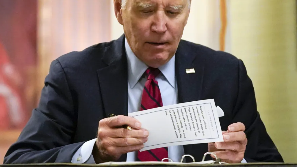 President Joe Biden puts a notecard away after signing a condolence book at the Apostolic Nunciature of the Holy See in Washington, Thursday, Jan. 5, 2023, for Pope Emeritus Benedict XVI. Benedict died at 95 on Dec. 31, 2022, in the monastery on the Vatican grounds where he had spent nearly all of his decade in retirement. (AP Photo/Patrick Semansky)