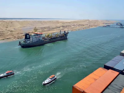A cargo ship is seen crossing through the New Suez Canal, Ismailia, Egypt, in this July 25, 2015 file photo. Egypt will open an expansion to the Suez Canal to great fanfare on August 6, 2015, the centrepiece of President Abdel Fattah al-Sisi's plans to revitalise the country's economy. To match EGYPT-SUEZCANAL/ REUTERS/Stringer/Files