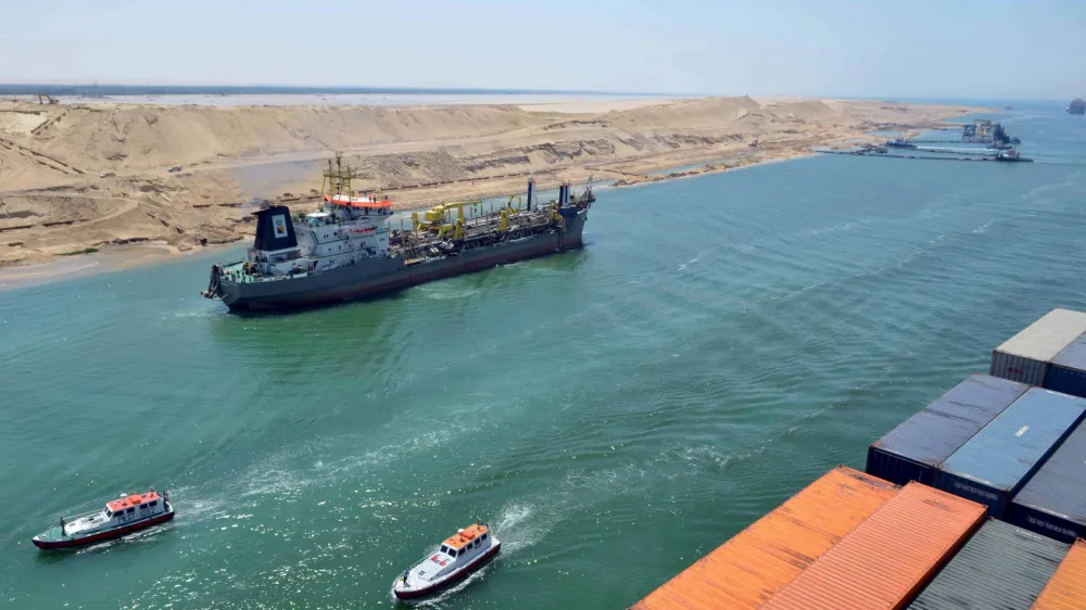 A cargo ship is seen crossing through the New Suez Canal, Ismailia, Egypt, in this July 25, 2015 file photo. Egypt will open an expansion to the Suez Canal to great fanfare on August 6, 2015, the centrepiece of President Abdel Fattah al-Sisi's plans to revitalise the country's economy. To match EGYPT-SUEZCANAL/ REUTERS/Stringer/Files
