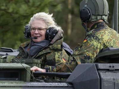 FILE - Christine Lambrecht, Minister of Defense, rides in a tank during her visit to the Tank Training Brigade 9 in Munster, Germany, Feb. 7, 2022. Defense Minister Christine Lambrecht resigns. She has asked Chancellor Olaf Scholz to dismiss her, said a statement from the minister on Monday. (Philipp Schulze/dpa via AP, File)