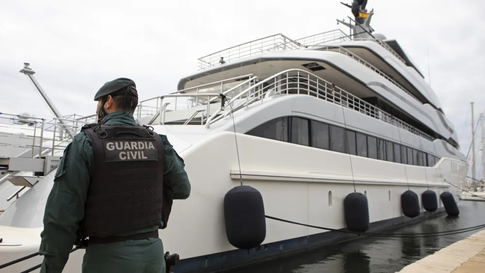 FILE - A Civil Guard stands by the yacht called Tango in Palma de Mallorca, Spain, April 4, 2022. Two businessmen have been charged with trying to conceal a sanctioned Russian oligarch's ownership of the luxury yacht seized in Spain last year by the U.S. government, the Justice Department said Friday, Jan. 20, 2023. (AP Photo/Francisco Ubilla, File)