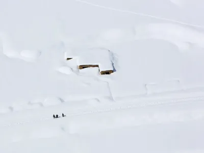 A house is covered with snow from an avalanche in the Paryan district of Panjshir province, north of Kabul, Afghanistan, Friday, Feb. 27, 2015. The death toll from severe weather that caused avalanches and flooding across much of Afghanistan has jumped to more than 200 people, and the number is expected to climb with cold weather and difficult conditions hampering rescue efforts, relief workers and U.N. officials said Friday. (AP Photo/Rahmat Gul)