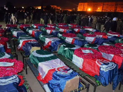 In this handout photo released by Pakistan's Police Department, security officials gather for funeral prayers of police officer, who were killed in the suicide bombing inside a mosque, in Peshawar, Pakistan, Monday, Jan. 30, 2023. A suicide bomber struck Monday inside a mosque in the northwestern Pakistani city of Peshawar, killing multiple people and wounding scores of worshippers, officials said. (Pakistan's Police Department via AP)