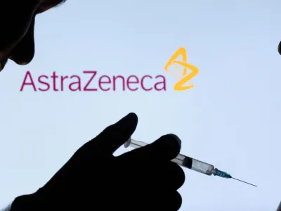 FILE PHOTO: People pose with syringe with needle in front of displayed AstraZeneca logo in this illustration taken, December 11, 2021. REUTERS/Dado Ruvic/Illustration/File Photo