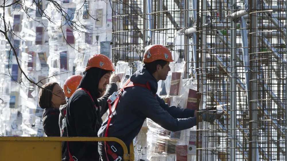 Workers hang books wrapped in plastic on the steel construction frame for the documenta art work "The Parthenon of Books' in Kassel, Germany, 24 April 2017. The reconstruction of the Parthenon temple of the Argentinian artist Marta Minujin is one of the largest projects of the Documenta. The Documenta will take place in Kassel from the 10th of June to the 17th of September 2017. Photo by: Swen Pf'rtner/picture-alliance/dpa/AP Images