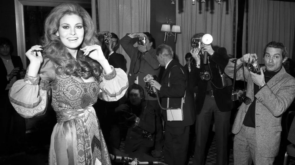 FILE - American actress Raquel Welch poses for photographers in Paris on Jan. 15, 1970. Welch, whose emergence from the sea in a skimpy, furry bikini in the film "One Million Years B.C." would propel her to international sex symbol status throughout the 1960s and '70s, died early Wednesday, Feb. 15, 2023, after a brief illness. She was 82. (AP Photo/Michel Lipchitz, File)