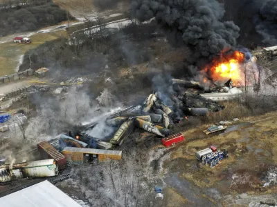 FILE - In this photo taken with a drone, portions of a Norfolk Southern freight train that derailed the previous night in East Palestine, Ohio, remain on fire at mid-day on Feb. 4, 2023. Transportation Secretary Pete Buttigieg announced a package of reforms to improve safety Tuesday, Feb. 21 &mdash; two days after he warned the railroad responsible for the derailment, Norfolk Southern, to fulfill its promises to clean up the mess just outside East Palestine, and help the town recover. (AP Photo/Gene J. Puskar, File)