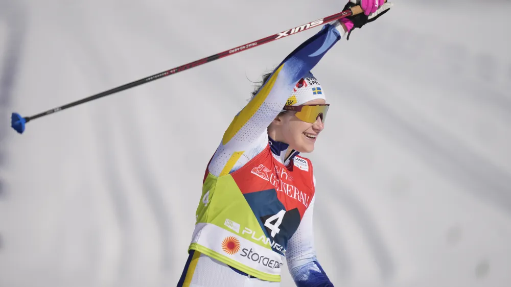 Sweden's Ebba Andersson celebrates her victory in the Women 30 km Mass Start Classic competition at the Nordic World Championships in Planica, Slovenia, Saturday, March 4, 2023. (AP Photo/Matthias Schrader)