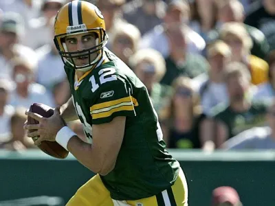 Green Bay Packers quarterback Aaron Rodgers rolls out to pass during the second quarter of an NFL preseason football game against the Tennessee Titans Friday, Sept. 1, 2006, in Green Bay, Wis. (AP Photo/ Mike Roemer)