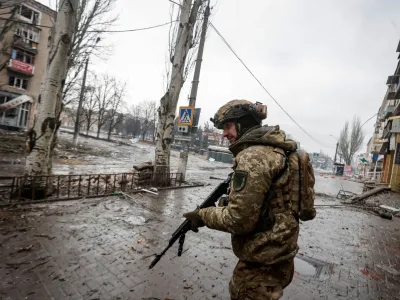 A Ukrainian serviceman walks an empty street, as Russia's attack on Ukraine continues, in the front line city of Bakhmut, in Donetsk region, Ukraine February 25, 2023. Radio Free Europe/Radio Liberty/Serhii Nuzhnenko via REUTERS THIS IMAGE HAS BEEN SUPPLIED BY A THIRD PARTY.