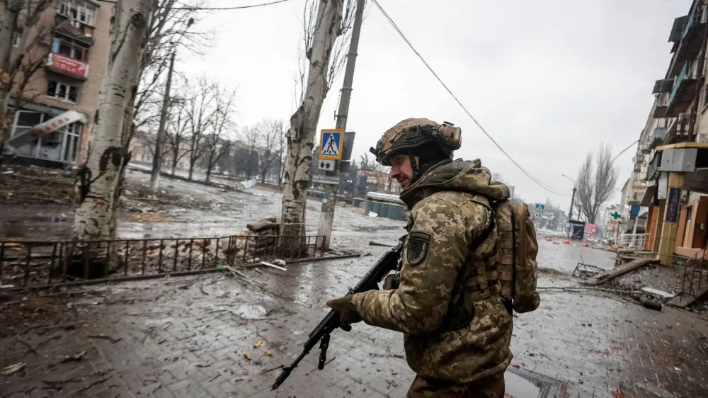 A Ukrainian serviceman walks an empty street, as Russia's attack on Ukraine continues, in the front line city of Bakhmut, in Donetsk region, Ukraine February 25, 2023. Radio Free Europe/Radio Liberty/Serhii Nuzhnenko via REUTERS THIS IMAGE HAS BEEN SUPPLIED BY A THIRD PARTY.