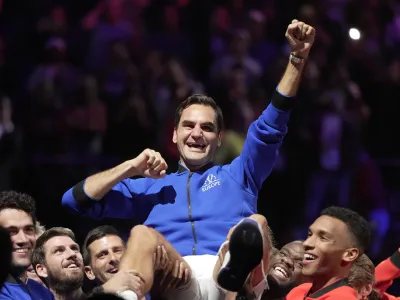 Team Europe's Roger Federer is lifted by fellow players after playing with Rafael Nadal in a Laver Cup doubles match against Team World's Jack Sock and Frances Tiafoe at the O2 arena in London, Friday, Sept. 23, 2022. Federer's losing doubles match with Nadal marked the end of an illustrious career that included 20 Grand Slam titles and a role as a statesman for tennis. (AP Photo/Kin Cheung)