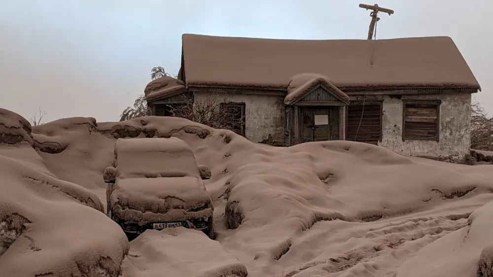 A view shows a house and a car covered in volcanic dust following the eruption of Shiveluch volcano in Kamchatka region, Russia April 11, 2023 in this picture obtained from a handout. Institute of Volcanology and Seismology/Handout via REUTERS  THIS IMAGE HAS BEEN SUPPLIED BY A THIRD PARTY MANDATORY CREDIT NO RESALES. NO ARCHIVES