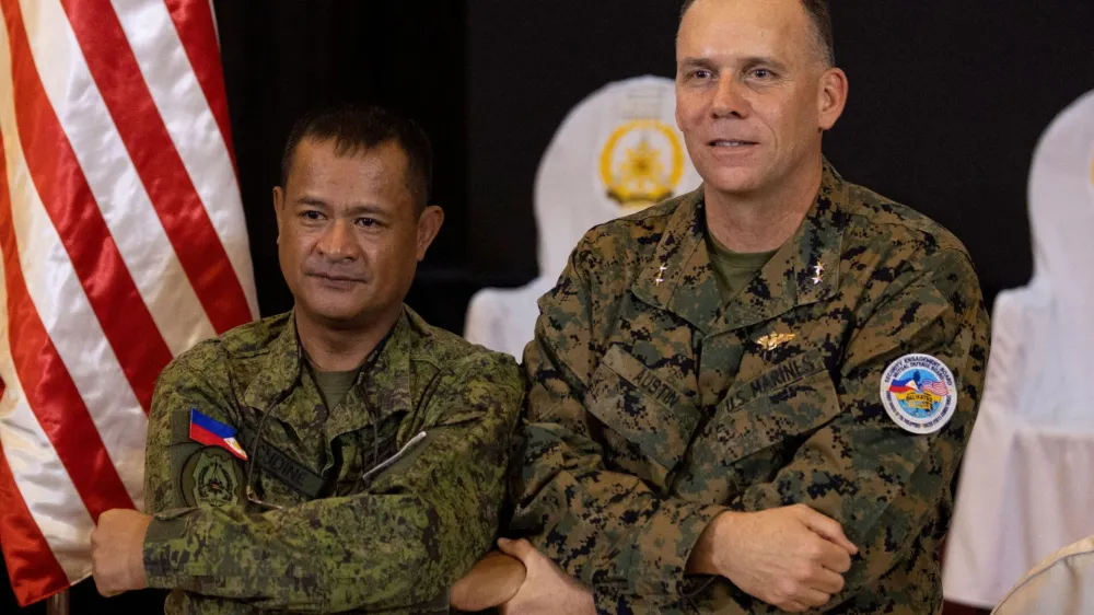 Philippines Exercise Director Major General Marvin Licudine links arms with U.S. Exercise Director representative Major General Eric Austin after the news conference on the opening ceremony of the annual Philippines-U.S. joint military exercises or Balikatan, at the Armed Forces of the Philippines headquarters, in Quezon City, Metro Manila, Philippines, April 11, 2023. REUTERS/Eloisa Lopez