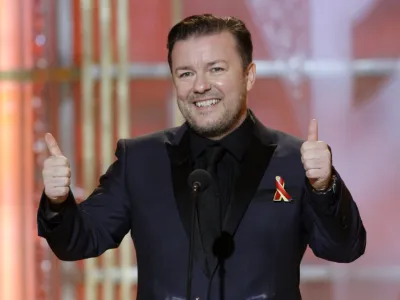 FILE - In this Jan. 17, 2010 file photo released by NBC, host Ricky Gervais gestures on stage during the 67th Annual Golden Globe Awards held at the Beverly Hilton Hotel. (AP Photo/NBC, Paul Drinkwater, file)