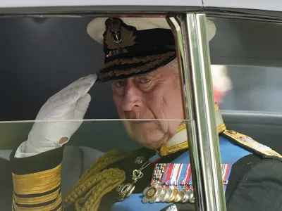 FILE - King Charles III salutes as he leaves Westminster Abbey following the state funeral service of Queen Elizabeth II in Westminster Abbey in central London, England, Monday Sept. 19, 2022.After waiting 74 years to become king, Charles has used his first six months on the throne to meet faith leaders across the country, reshuffle royal residences and stage his first overseas state visit. With the coronation just weeks away, Charles and the Buckingham Palace machine are working at top speed to show the new king at work. (AP Photo/Martin Meissner, File)