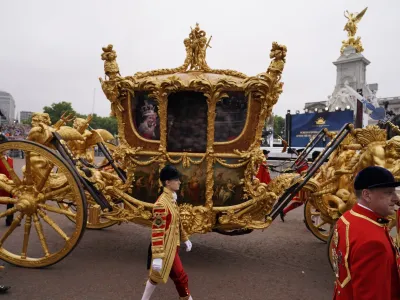 The image of Queen Elizabeth II is seen in a golden carriage during the Platinum Jubilee Pageant outside the Buckingham Palace in London, Sunday, June 5, 2022, on the last of four days of celebrations to mark the Platinum Jubilee. The pageant will be a carnival procession up The Mall featuring giant puppets and celebrities that will depict key moments from the Queen Elizabeth II's seven decades on the throne. (AP Photo/Alberto Pezzali, Pool)