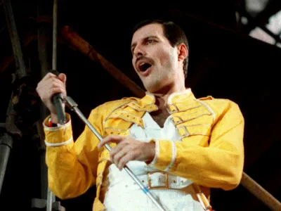 FILE - Queen lead singer Freddie Mercury performs, in Cologne, Germany, on Sunday, July 20, 1986 file photo. Freddie Mercury's extensive collection of costumes, fine art, and even handwritten working lyrics to "We Are the Champions" will be auctioned in Sept. 2023. (AP Photo/Marco Arndt, File)