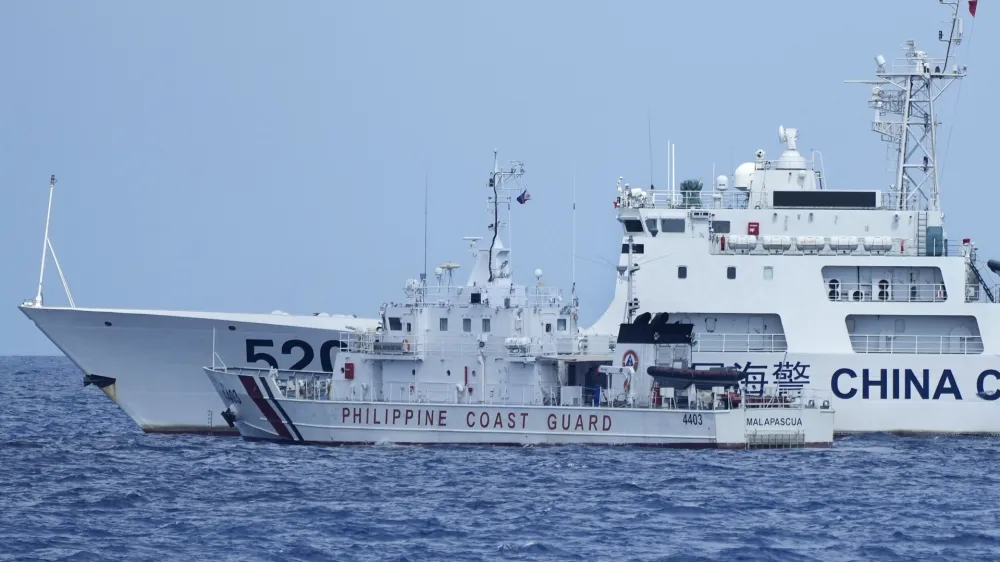A Chinese Coast Guard ship with bow number 5201 blocks Philippine Coast Guard ship BRP Malapascua as it maneuvers to enter the mouth of the Second Thomas Shoal locally known as Ayungin Shoal at the South China Sea on Sunday, April 23, 2023. The near-collision was among the tense confrontations encountered by two Philippine government vessels against China, which undertook a weeklong voyage in one of the world's most hotly contested sea passages to assert Philippine sovereignty. (AP Photo/Aaron Favila)