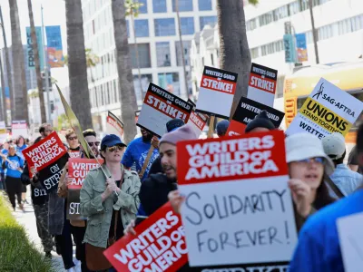 Workers and supporters of the Writers Guild of America protest outside the Netflix offices after union negotiators called a strike for film and television writers in Los Angeles, California, U.S., May 2, 2023. REUTERS/Aude Guerrucci