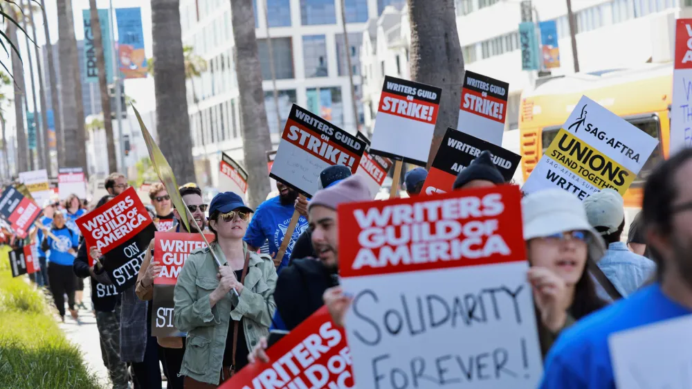 Workers and supporters of the Writers Guild of America protest outside the Netflix offices after union negotiators called a strike for film and television writers in Los Angeles, California, U.S., May 2, 2023. REUTERS/Aude Guerrucci