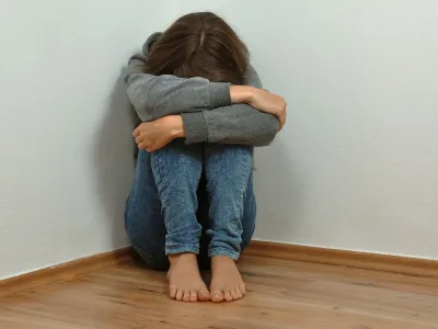 Lonely girl crying in the corner