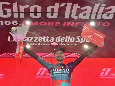 Cycling - Giro d'Italia - Stage 14 - Sierre to Cassano Magnago - Italy - May 20, 2023 BORA &ndash; hansgrohe's Nico Denz celebrates on the podium after winning stage 14 REUTERS/Jennifer Lorenzini