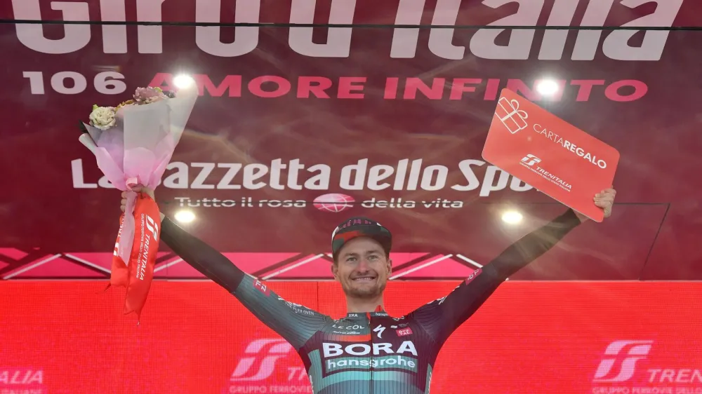 Cycling - Giro d'Italia - Stage 14 - Sierre to Cassano Magnago - Italy - May 20, 2023 BORA &ndash; hansgrohe's Nico Denz celebrates on the podium after winning stage 14 REUTERS/Jennifer Lorenzini