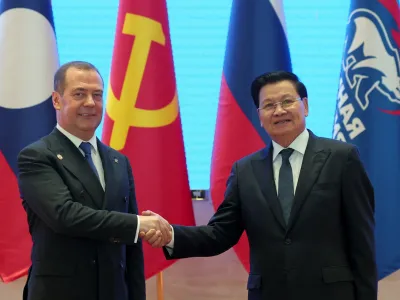 Russian Security Council Deputy Chairman and the head of the United Russia party Dmitry Medvedev, left, and Laos' President Thongloun Sisoulith shake hands during their meeting in Vientiane, Laos, on Tuesday, May 23, 2023. (Ekaterina Shtukina/Pool Sputnik via AP)