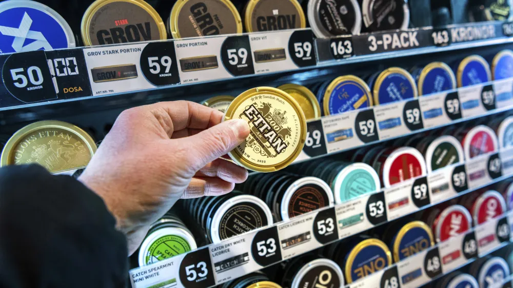 FILE - A man holds a box of snus (snuff), at a store in Stockholm, on Jan. 23, 2023. Sweden, which has the lowest rate of smoking in Europe is now close to declaring itself "smoke free," defined as having less than 5% daily smokers in the population. Some experts give credit to decades of anti-smoking campaigns and legislation, while others point to the prevalence of "snus," a smokeless tobacco product that's illegal elsewhere in the European Union but is marketed in Sweden as an alternative to cigarettes. (Claudio Bresciani /TT News Agency via AP, File)