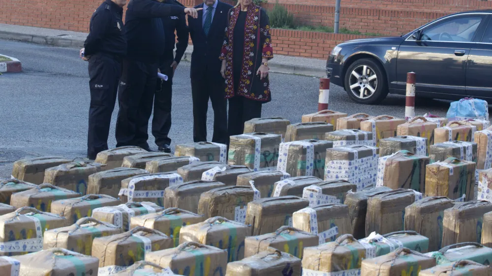 Madrid regional government delagate Cristina Cifuentes, right and the chief of Spain's national police force, Ignacio Cosido 2nd right look at part of a haul of hashish and marijuana in Madrid, Wednesday Dec. 26, 2012. Spanish police have seized 11 metric tons (12.1 U.S. tons) of hashish smuggled from Morocco on trucks with tanks rigged to hide the drugs. Thirty five people were arrested in what was described as the breakup of a major smuggling ring that fed the European market. Authorities said in a statement Wednesday that the hashish was sent to a Madrid suburb for distribution to countries including Belgium, Britain, France and Holland. (AP Photo/Paul White)