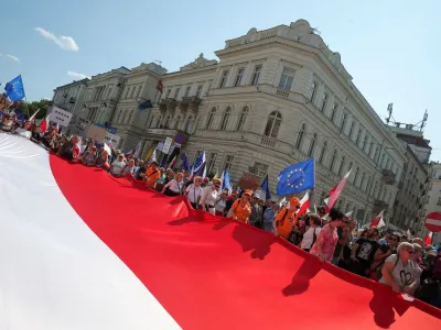 People carry a giant Polish flag during a march on the 34th anniversary of the first democratic elections in postwar Poland, in Warsaw, Poland, June 4, 2023. REUTERS/Kacper Pempel