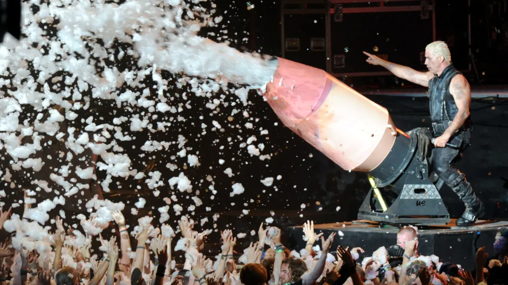 FILED - 01 August 2013, Schleswig-Holstein, Wacken: Till Lindemann, lead singer of the German metal band Rammstein, sprays the audience with a foam cannon during a concert in Wacken. Lawyers for Till Lindemann say they will take legal action against those alleging he committed crimes against women. Photo: Carsten Rehder/dpa