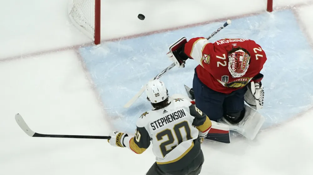 Vegas Golden Knights center Chandler Stephenson (20) scores goal past Florida Panthers goaltender Sergei Bobrovsky (72) during the first period in Game 4 of the NHL hockey Stanley Cup Finals, Saturday, June 10, 2023, in Sunrise, Fla. (AP Photo/Lynne Sladky)