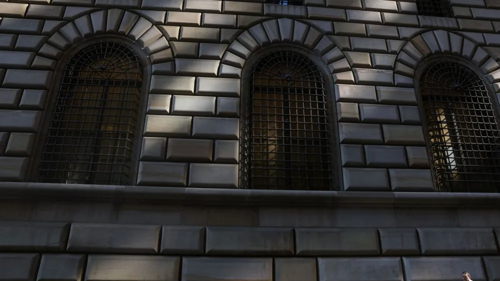 People walk by the Federal Reserve Bank of New York in the financial district of New York City, U.S., June 14, 2023. REUTERS/Shannon Stapleton