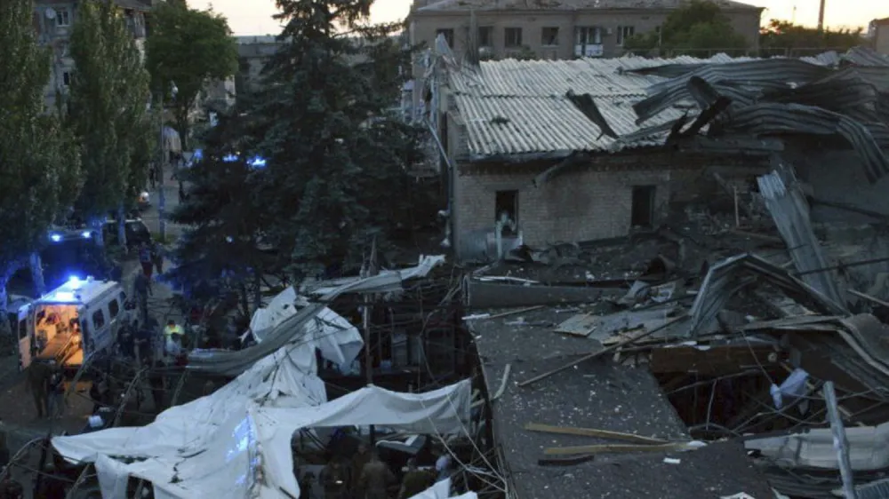 In this photo provided by the National Police of Ukraine, people clear the rubble in a restaurant RIA Pizza destroyed by a Russian attack in Kramatorsk, Ukraine, Tuesday, June 27, 2023. (National Police of Ukraine via AP)