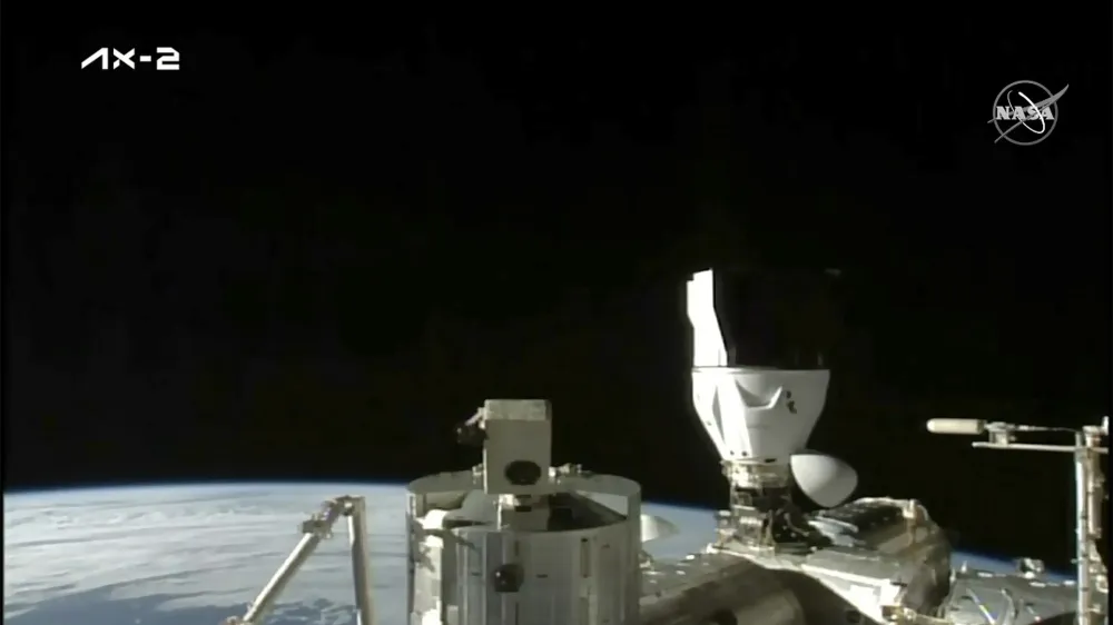 In this image from NASA TV, the sun rises over the International Space Station after a SpaceX capsule docked, Monday, May 22, 2023. The space station rolled out the welcome mat for two Saudi visitors, including the kingdom's first female astronaut. (NASA TV via AP)