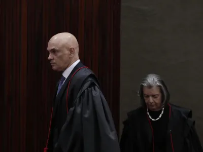 President of the Supreme Electoral Court, Minister Alexandre de Moraes, left, and Minister Carmen Lucia arrive to preside over the trial of former President Jair Bolsonaro at the Supreme Court in Brasilia, Brazil, Friday, June 30, 2023. Judges continue evaluating the case which claims Bolsonaro abused his power by using government communication channels to promote his campaign and cast unfounded doubts on the country's electronic voting system. (AP Photo/Eraldo Peres)