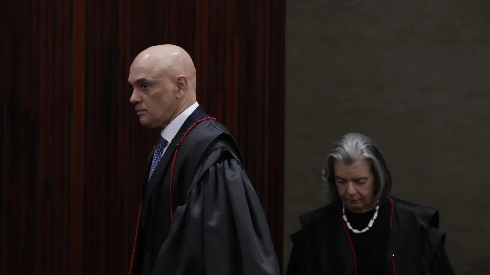 President of the Supreme Electoral Court, Minister Alexandre de Moraes, left, and Minister Carmen Lucia arrive to preside over the trial of former President Jair Bolsonaro at the Supreme Court in Brasilia, Brazil, Friday, June 30, 2023. Judges continue evaluating the case which claims Bolsonaro abused his power by using government communication channels to promote his campaign and cast unfounded doubts on the country's electronic voting system. (AP Photo/Eraldo Peres)