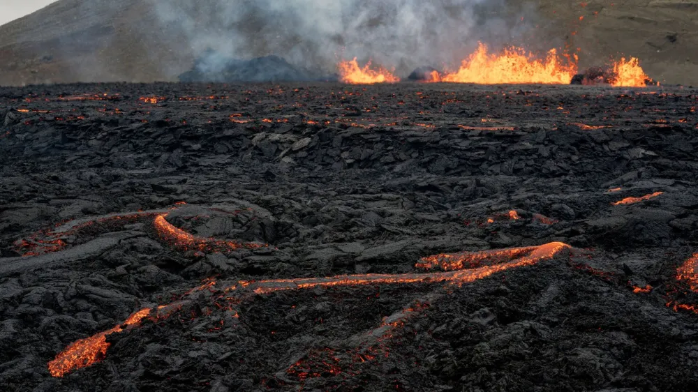 FILE PHOTO: Iceland's Fagradalsfjall volcano sputters lava from the uninhabited Meradalir Valley on the Reykjanes peninsula, about 20 miles from Reykjavik, Iceland August 5, 2022. REUTERS/Ken Cedeno/File Photo