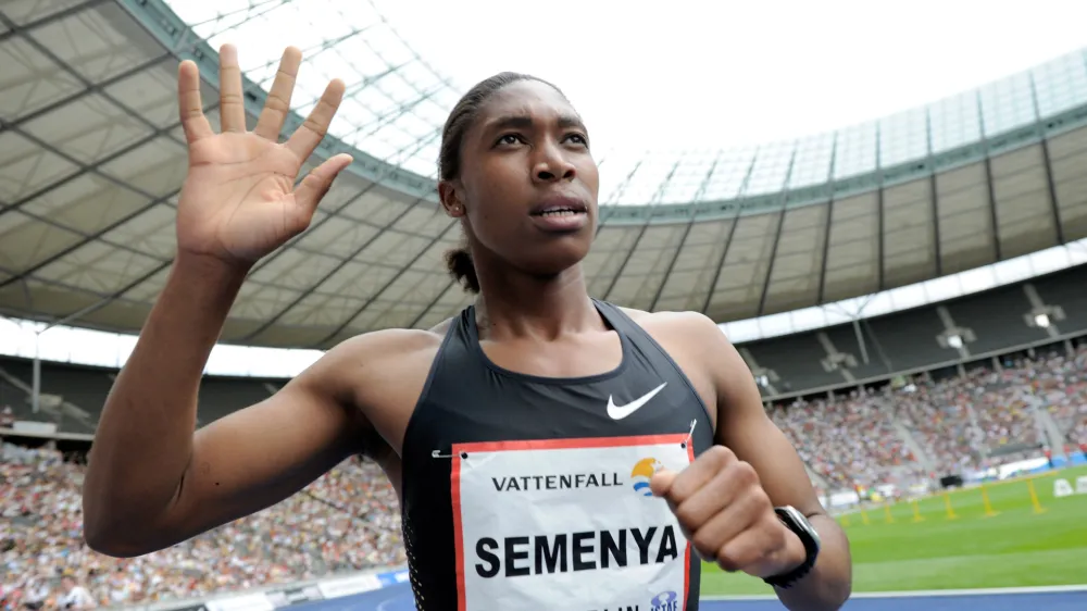 FILE - This Aug. 22, 2010, file photo shows Caster Semenya of South Africa gesturing after winning the women's 800 meter final of the ISTAF Athletics Meeting at the Olympic stadium in Berlin, Germany. The International Olympic Committee has agreed to adopt rules for dealing with cases of female athletes who have excessive levels of male hormones. The issue of gender verification gained international prominence after Semenya was ordered to undergo sex tests after winning the 800 meters at the 2009 world championships. (AP Photo/Gero Breloer, File)