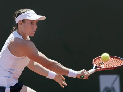 Tamara Zidansek from Slovenia returns a ball to Clara Burel from France during the final match at the tennis WTA International Ladies open in Lausanne, Switzerland, Sunday, July 18, 2021. (Cyril Zingaro/Keystone via AP)