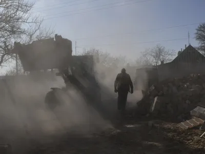 Local residents clear the rubble of a private house following a Russian rocket attack in Komyshevakha in Zaporizhzhya region, Ukraine, Friday, Feb. 10, 2023. (AP Photo/Andriy Andriyenko)