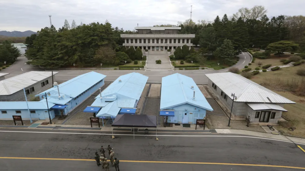 FILE - South Korean and U.S. Army soldiers, wearing gray uniforms, gather during a rehearsal to mark the first anniversary of a summit between South Korean President Moon Jae-in and North Korean leader Kim Jong Un, at the border village of Panmunjom in the demilitarized zone (DMZ) between the two Koreas in Paju, South Korea, on April 26, 2019. An American has crossed the heavily fortified border from South Korea into North Korea, the American-led U.N. Command overseeing the area said Tuesday, July 18, 2023, amid heightened tensions over North Korea's nuclear program. (AP Photo/Ahn Young-joon, File)